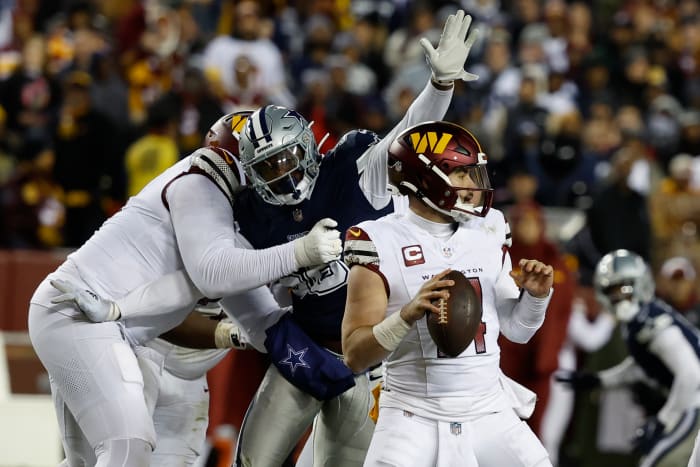 Washington Commanders quarterback Sam Howell (14) is sacked by Dallas Cowboys defensive end Dante Fowler Jr. (56) during the second quarter at FedExField. Mandatory Credit: Geoff Burke-USA TODAY Sports